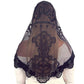 Black lace veil with intricate design on a white background